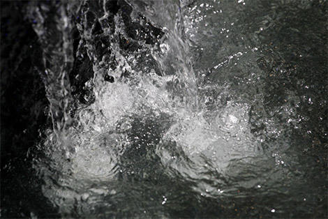 Wasser spritzt vor schwarzem Hintergrund